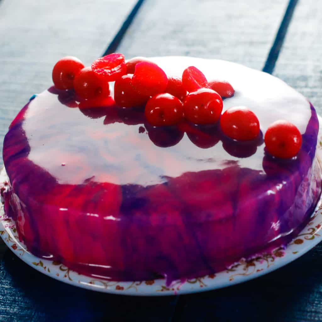 Delicious birthday cake on shiny purple background Stock Photo - Alamy